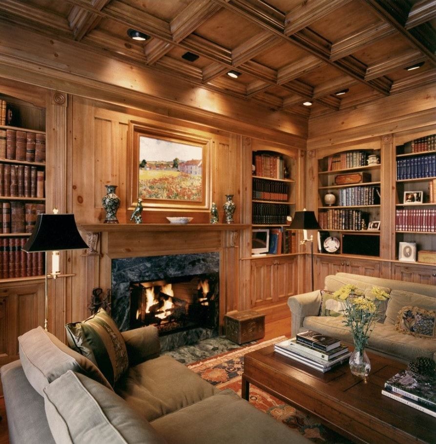 Impeccably designed wooden trimmed Classic living room with the cast-iron fireplace and coffered ceiling