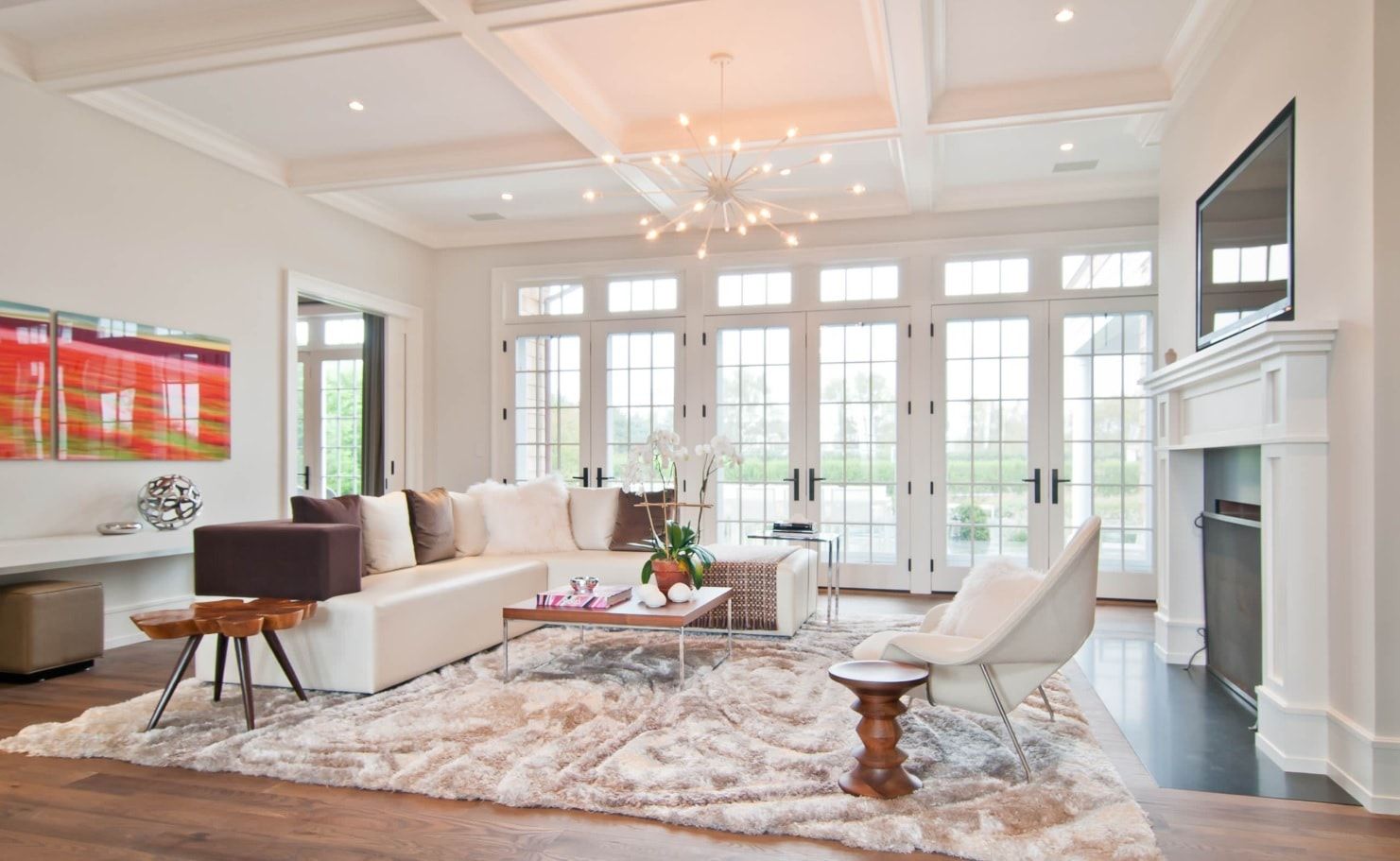 Classic snow white decoration for large living room with coffered ceiling and dotted chandelier