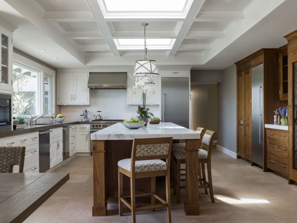 Modern designed kitchen in light colors with coffered ceiling with built-in lighting