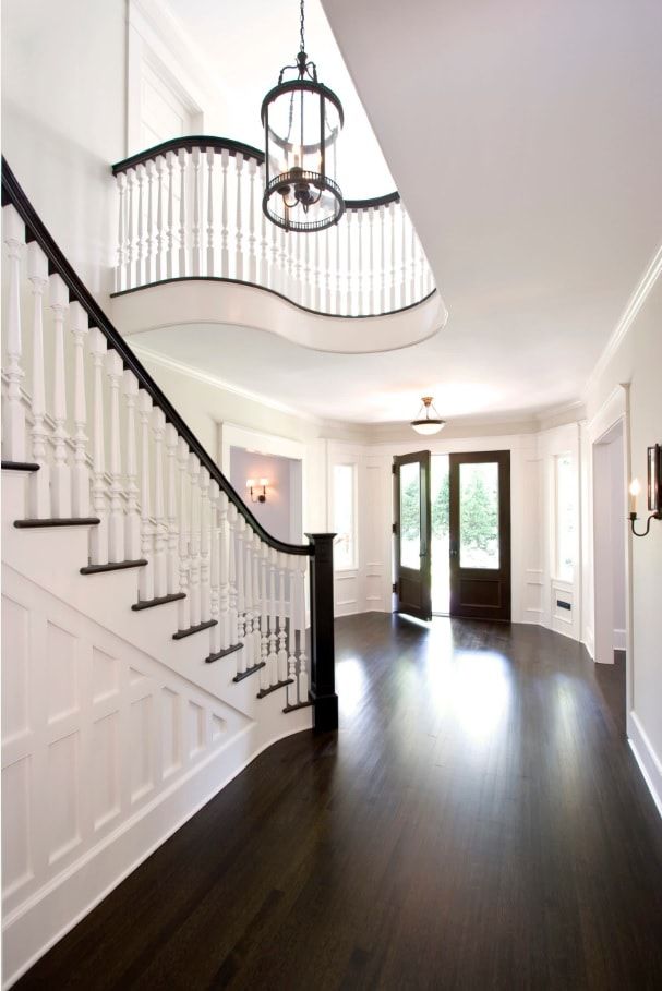 Classic design entrance and stairway in the house with black accentual floor