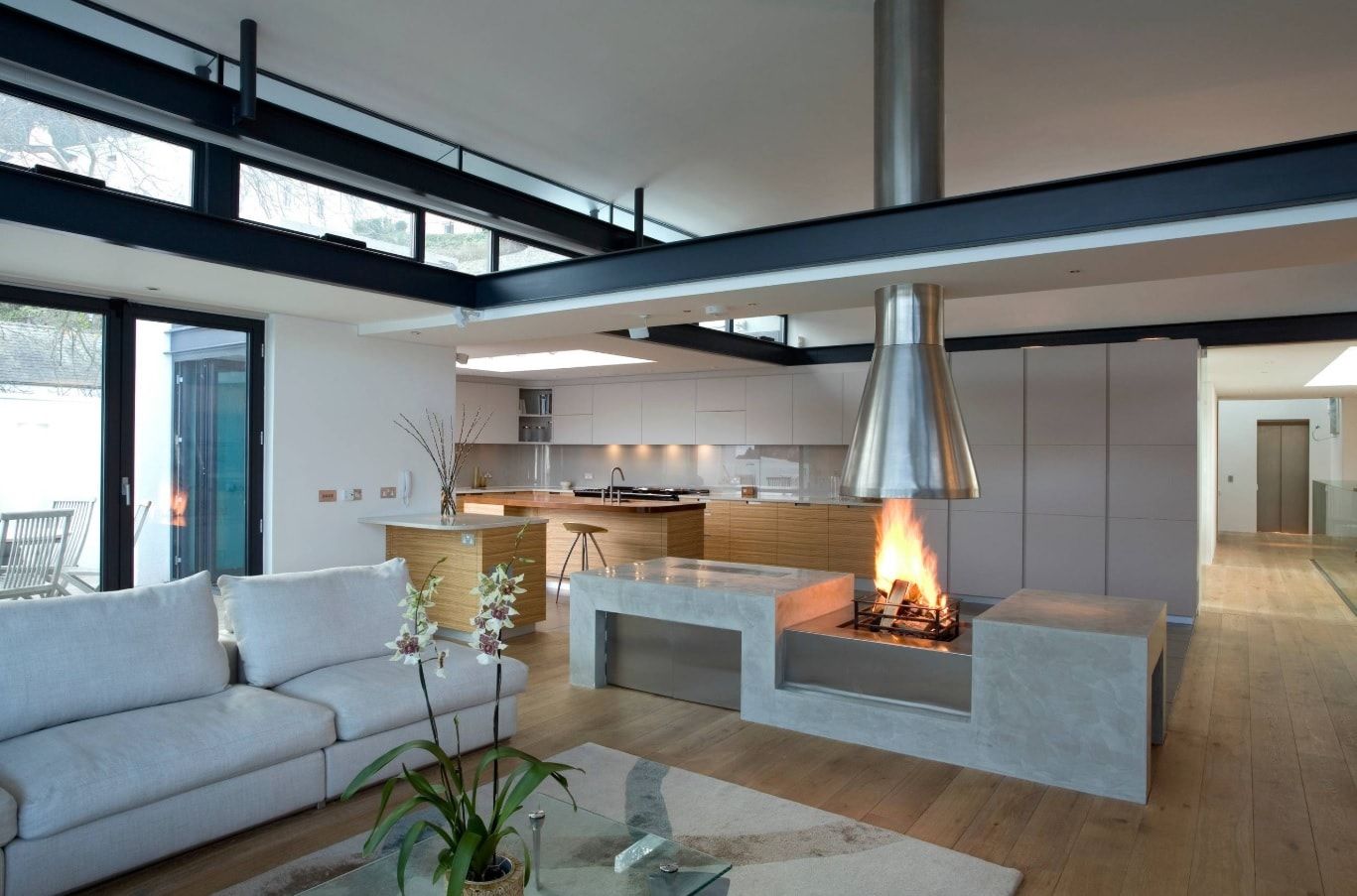 Asymmetric design for futuristic cottage with modular furniture and fireplace right at the cooking zone