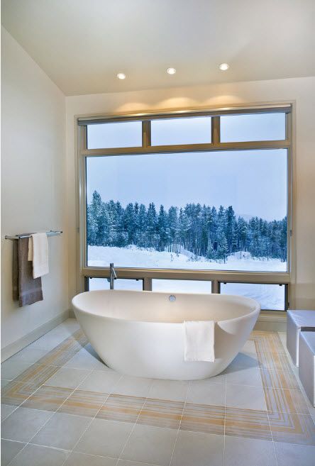 Acrylic Bathtub as the Highlight of Modern Bathroom Interior. Panoramic window in Scandinavian styled bathroom