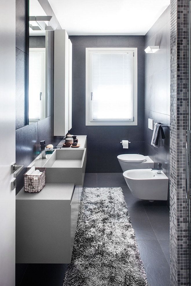 Bidet and toilet, gray vanity in the Contemporary space
