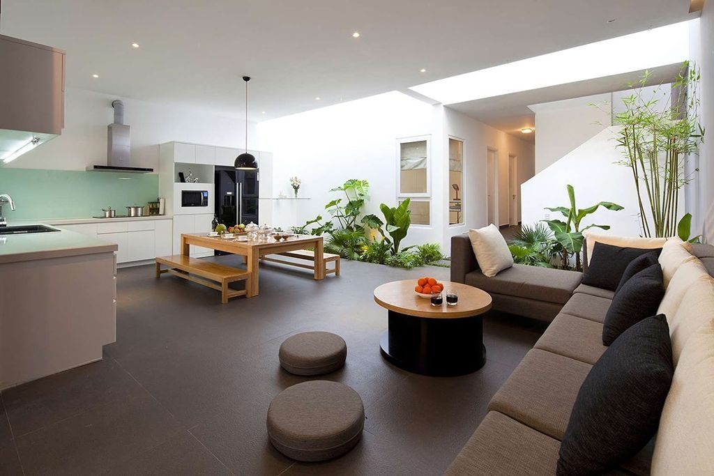 Gorgeous design of the open layout apartment with dark brown floor and white walls