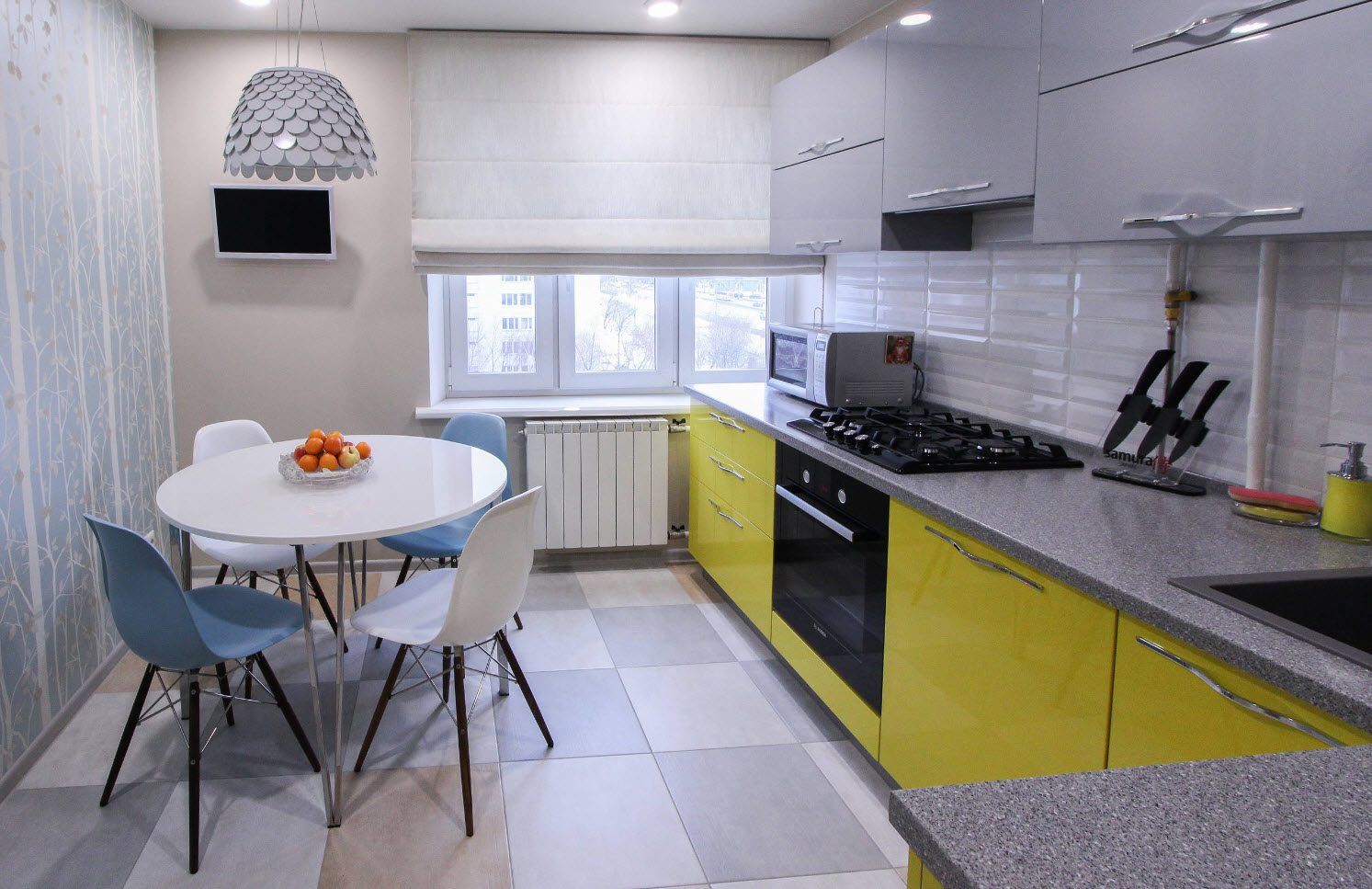 Yellow stain of low tier furniture facades on light idyll of the kitchen