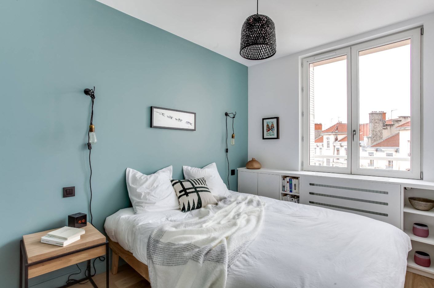 Aquamarine colored accent wall in the modern Scandi styled bedroom interior