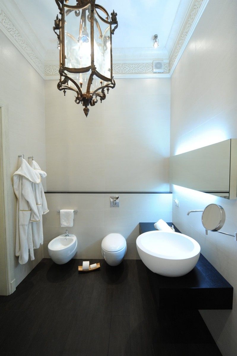 Side LED light in the modern solid design of the bathroom with bidet, bathtub and toilet 