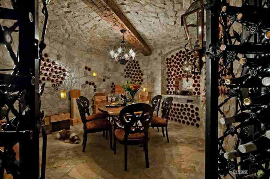 The wine bottles mounted right at the concrete base of the house