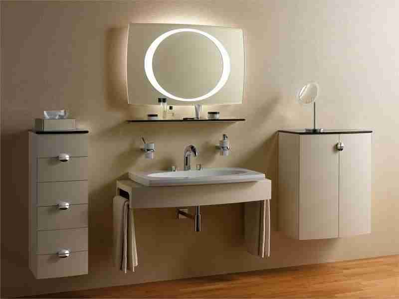 Beige colored bathroom with LED-lit round mirror