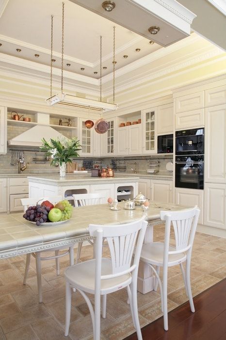 Italian Dining Room & Kitchen Combined in One Space. Nice milky gray shade in the kitchen in monolith styled space of large room