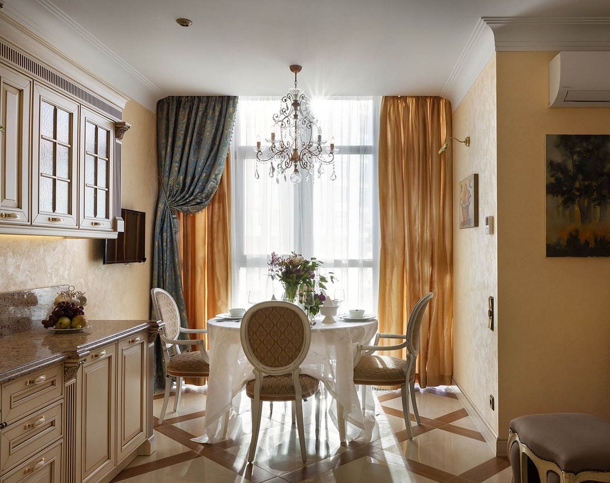 Italian Dining Room & Kitchen Combined in One Space. Orange cirtains and white round table in the center