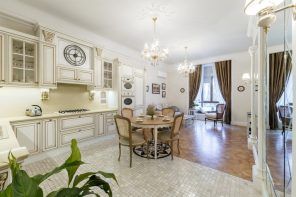 Italian Dining Room & Kitchen Combined in One Space. White decorated kitchen with two-zoned floor