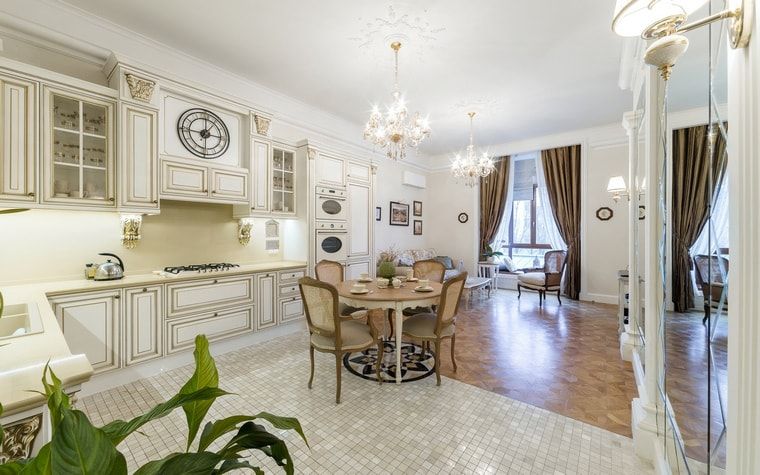 Italian Dining Room & Kitchen Combined in One Space. White decorated kitchen with two-zoned floor