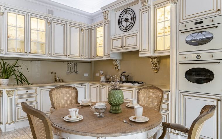 Italian Dining Room & Kitchen Combined in One Space. Carved wooden kitchen set and round wooden table