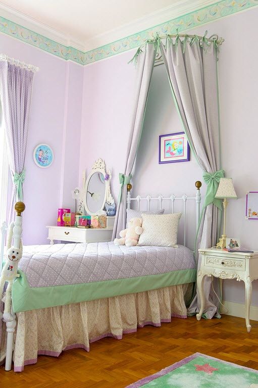 Light purple decorated walls in classic styled room with tulle above the bed