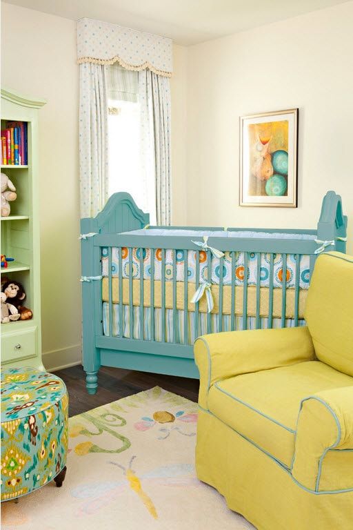 Yellow colored classic chair and blue crib