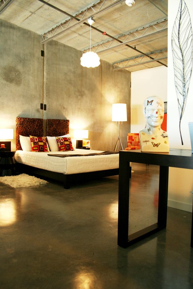 Gray designed industrial bedroom full of artificial lighting and faux concreted walls