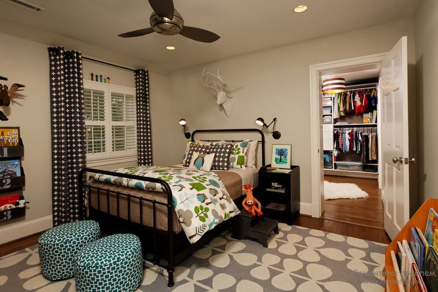 Curtains in the Interior of the Children’s Room. Black metal framed bed and the dark dotted drapes