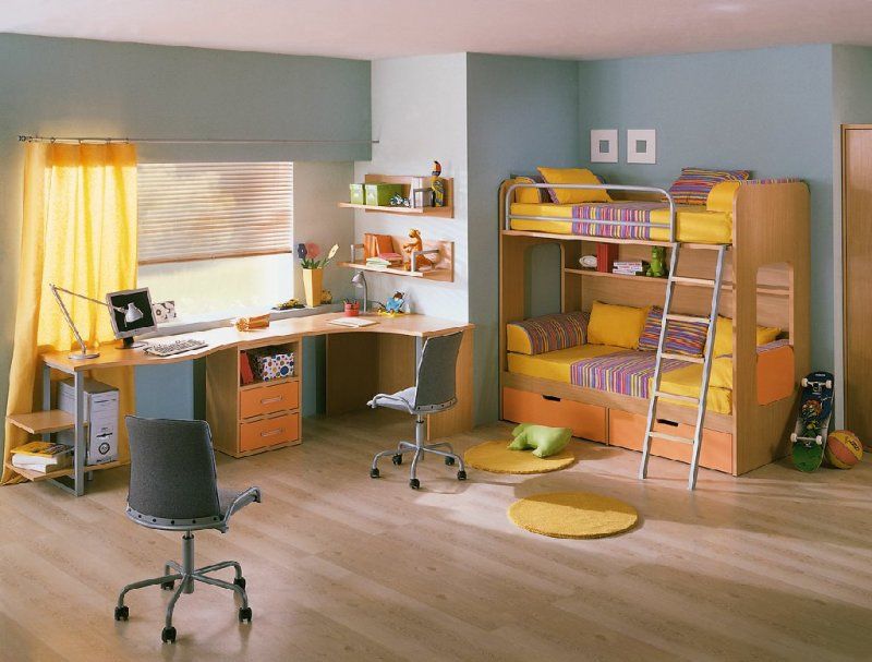 Yellow decorated bunk bed and table for studies along with pistachio walls
