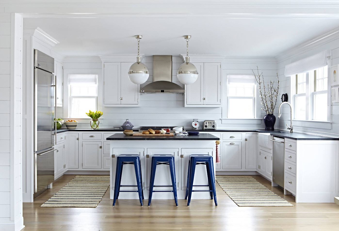 White colored kitchen with blue chairs