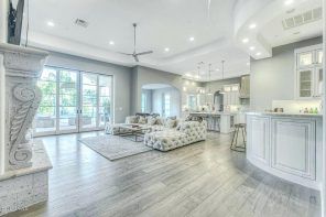 Light apartment with gray laminate and glossy white walls