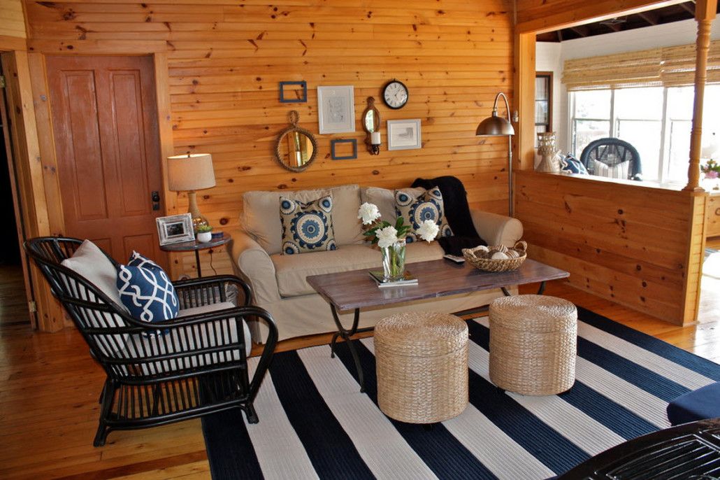 Wooden trim of the walls in the village cottage and the striped carpet