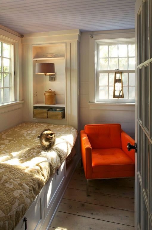 Orange armchair for rustic designed bedroom with sash-windows