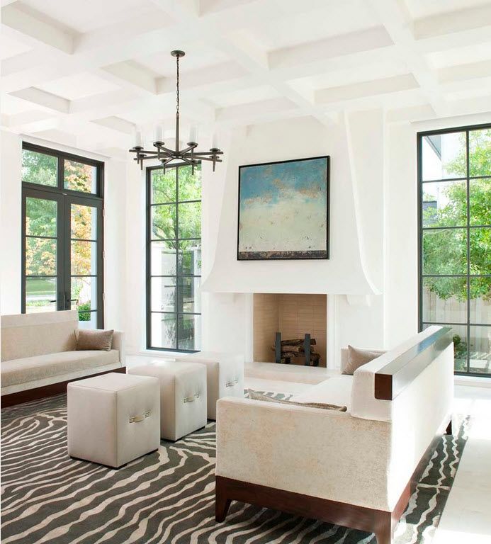 Absoultely white room with black framed windows and coffered ceiling