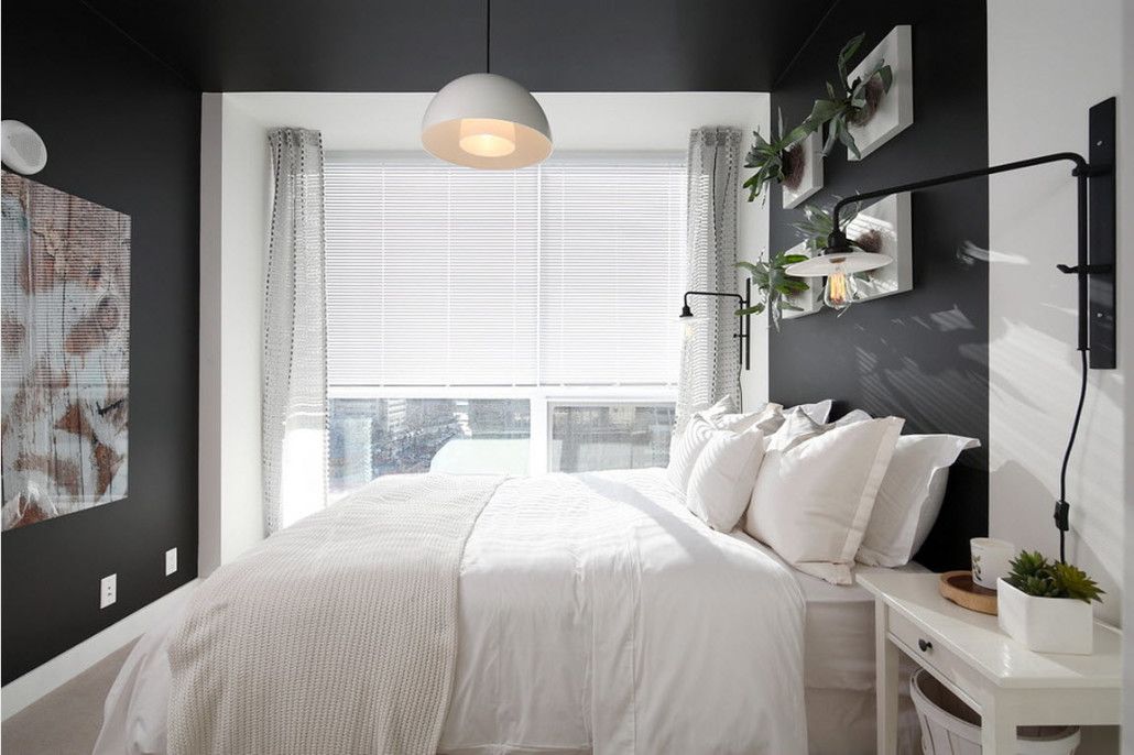 Gorgeous contrast in the casual styled room with dark walls and white bedding