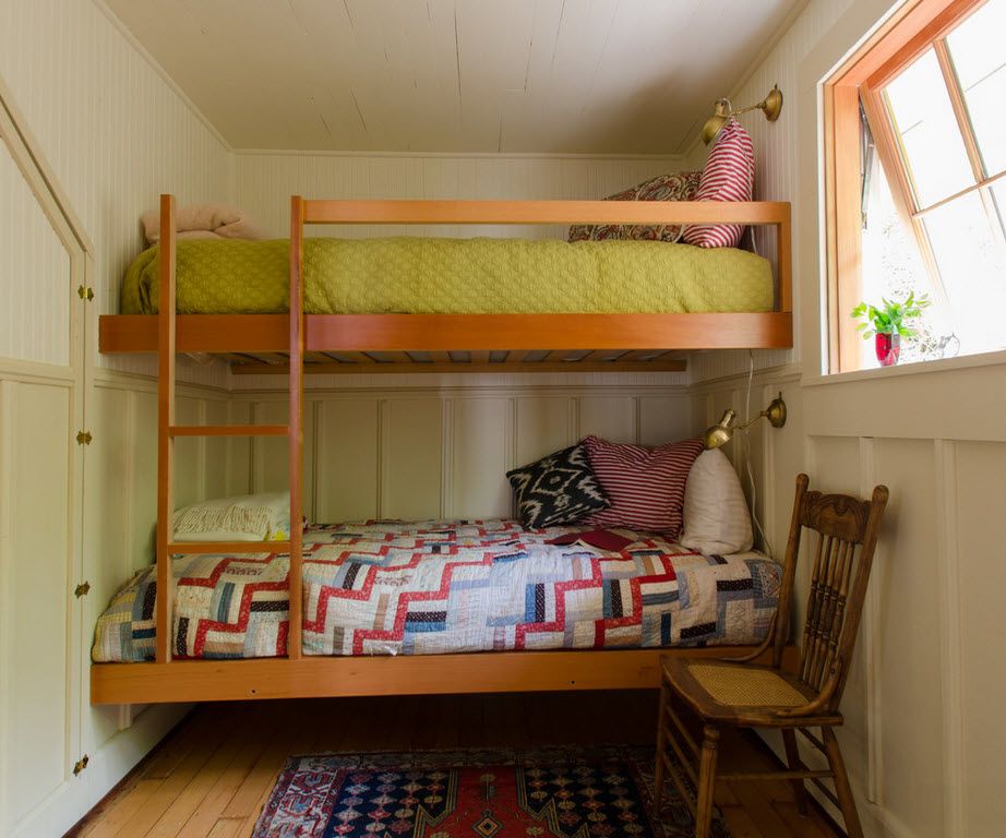 Small kids' room with wooden bunk bed and ladder