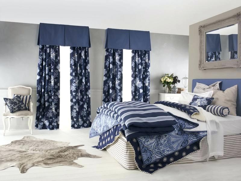 Blue curtains in the casual styled white and gray colored interior