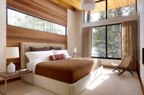 Window Design in the Bedroom for Ultimate Coziness and Comfort. Modern interior of the forest cottage with panoramic windows and wooden trimming