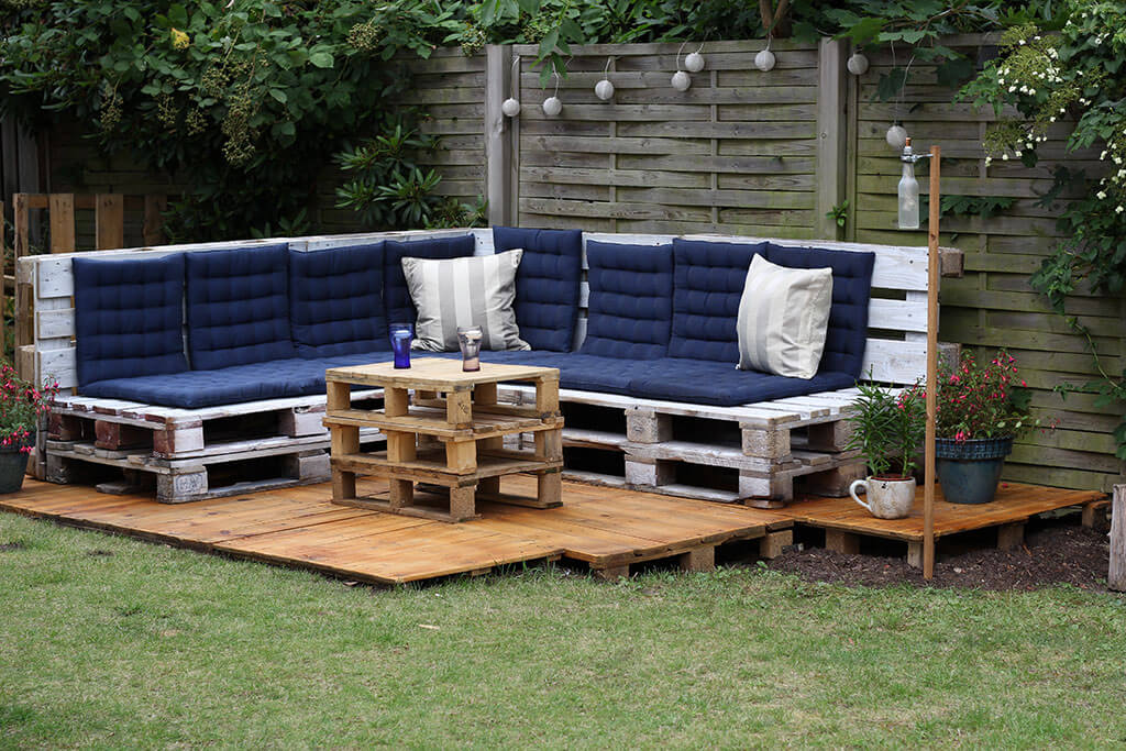 A really large resting zone with the angular seating construction and coffee table of pallets
