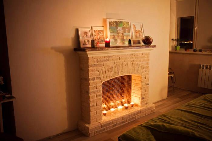White stone imitating DIY fireplace for the minimalistic living room