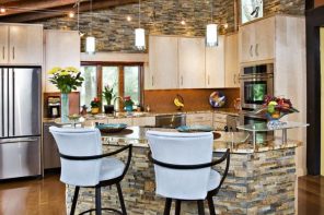 DIY Kitchen Renovation: Practical Advice on Design and Materials. Stone trimmed kitchen island with high chairs and open ceiling beams
