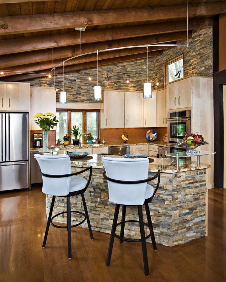 DIY Kitchen Renovation: Practical Advice on Design and Materials. Stone trimmed kitchen island with high chairs and open ceiling beams