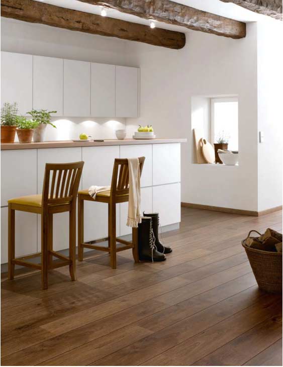 White kitchen with high wooden chairs and matted facades and walls