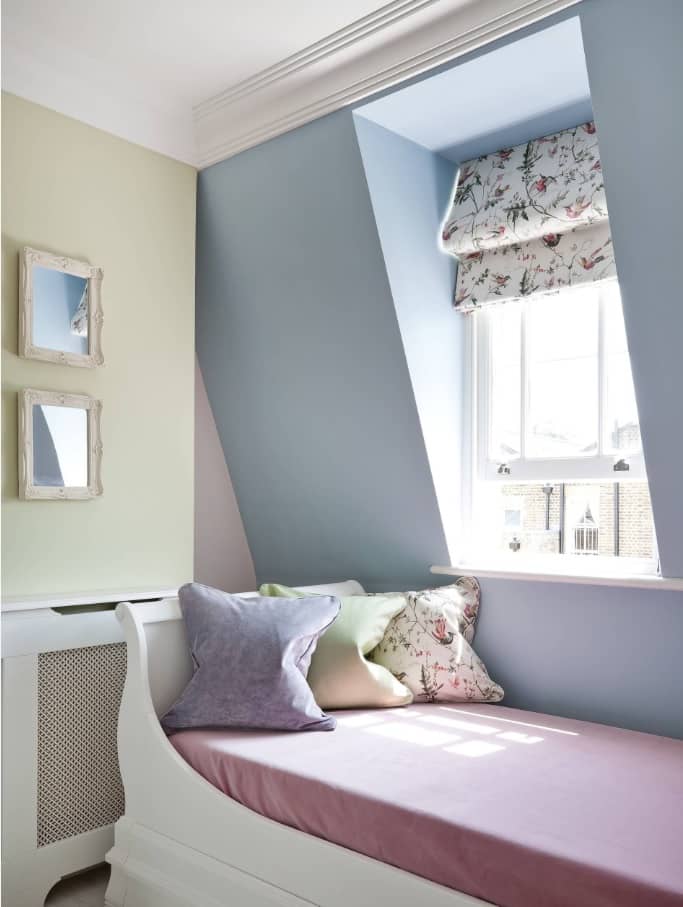 Lighting Tricks to Make a Small Home Feel Larger. Blue and pastel creamy color scheme for loft room with large window pane and Classic blinds