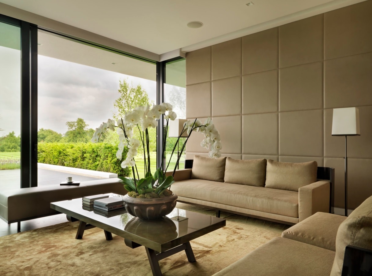 Utterly modern living room interior with panoramic windows and soft wall panels