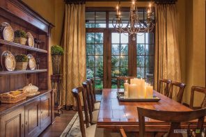 Long neutral ceurtains, wooden furniture and candles at the table of the Classic dining room