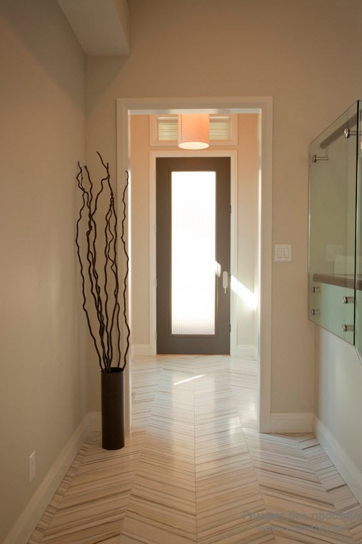 Light colored hallway with minimalistic arrangement and twigs in the vase