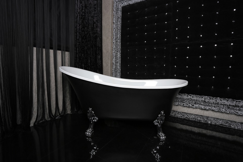 Black cast-iron bathtub in the center of black colored bathroom