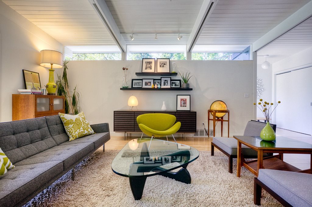 Unusual interior of the cottage with small ceiling windows and glass coffee table