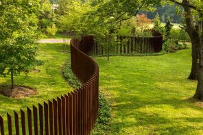 How to Choose the Appropriate Fence For Your Yard? Unusual wooden picket with sideway location of the logs