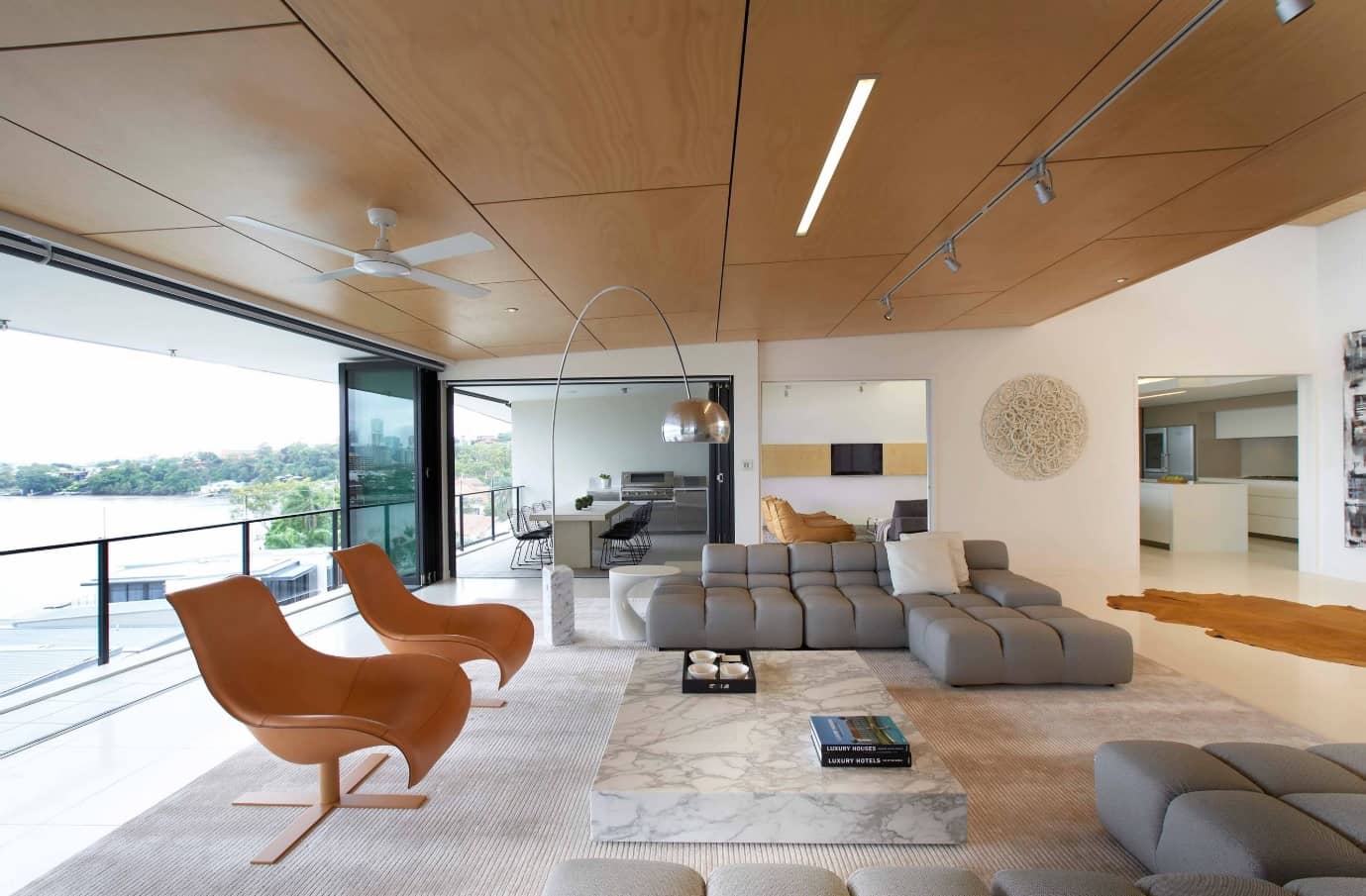 12 Ways You Could Make Your Home More Eco Friendly. Unusual designed modern living room with paneled ceiling, modular sofa, relaxing chairs and marble imitating stand as the coffee table