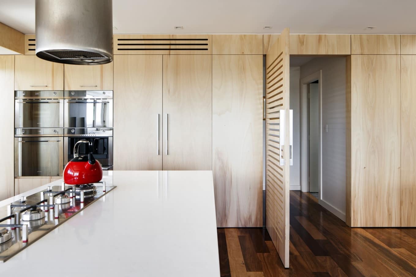 How to Redesign Your Kitchen This Summer. All-wooden decoration at the contemporary styled kitchen with dark glossy laminate and large countertop