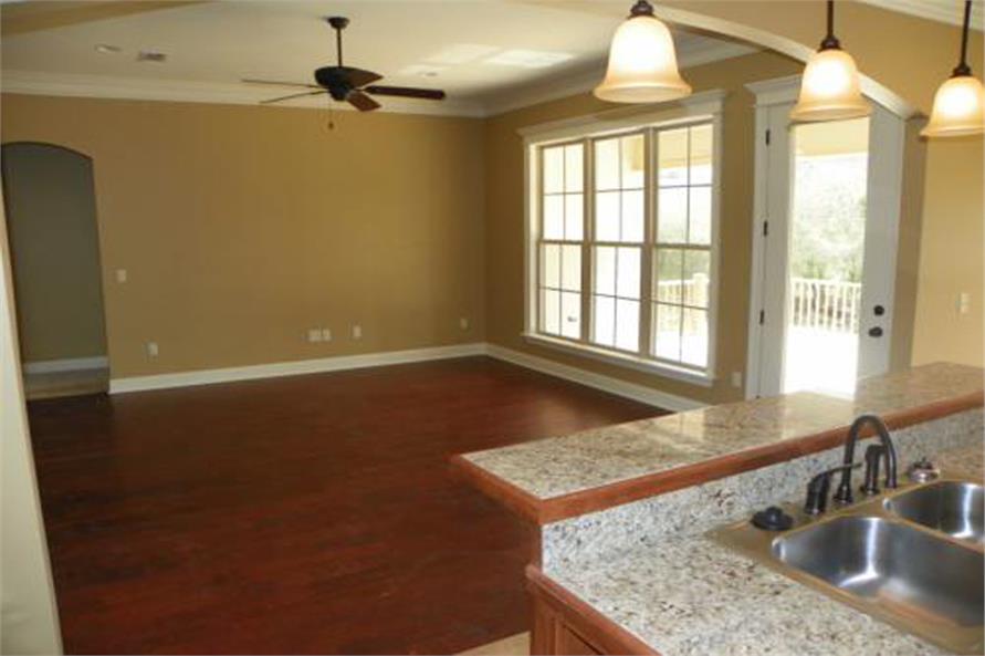 Simple designed large room with dark wooden laminate and brown painted walls