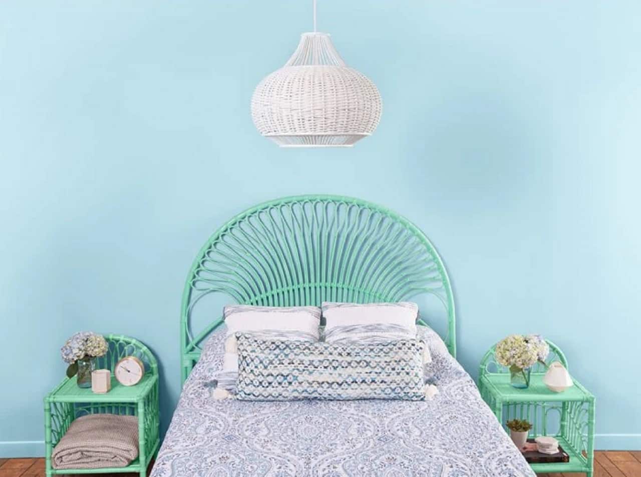 Classic bedroom with mild blue accent wall and turquoise furniture as well as nice weaved sconce over the bed