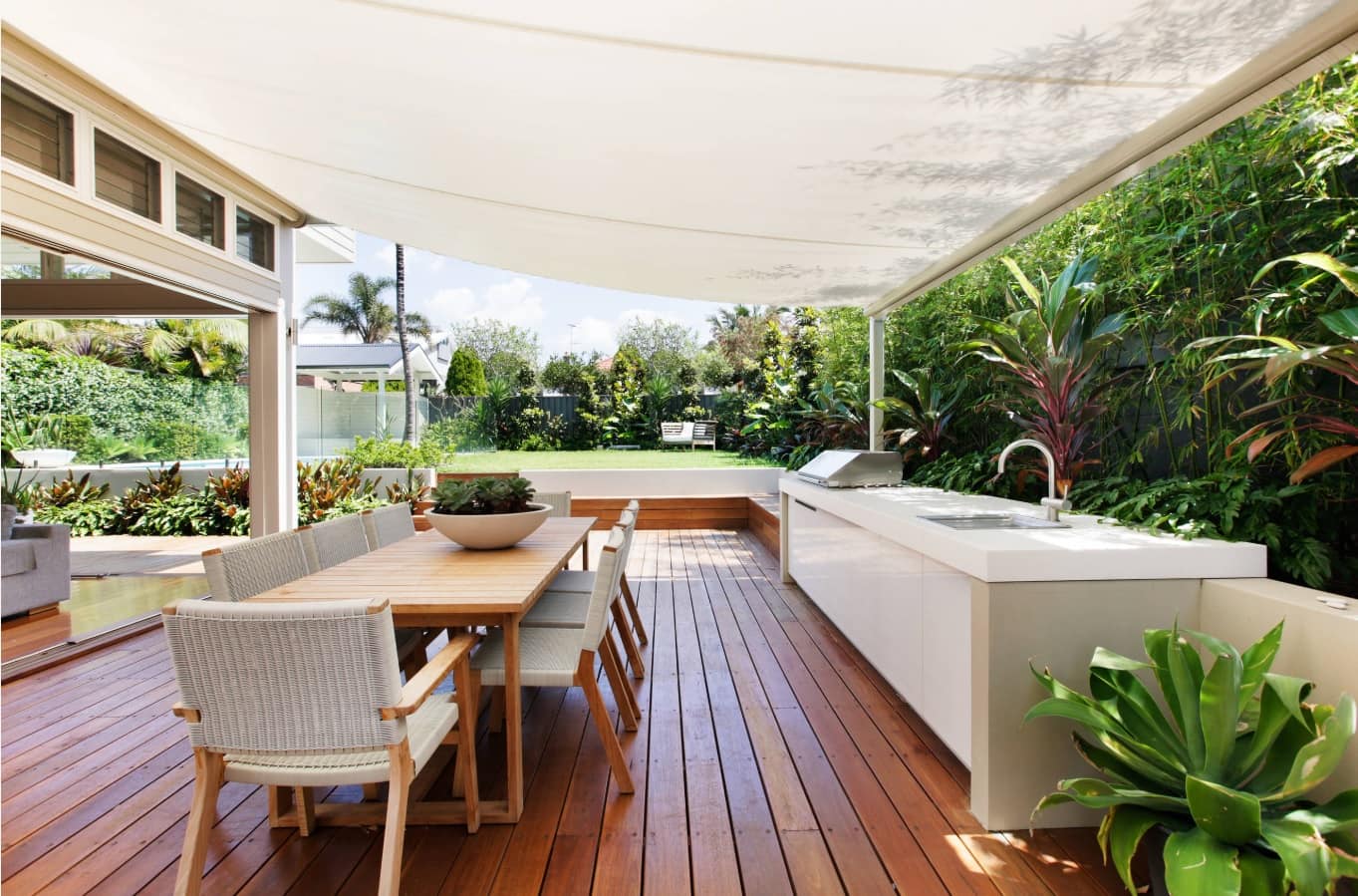 Retractable Patio Awnings Offer An Amazing Way to Upgrade Your Home. Large backyard deck patio with dining and barbecue zones