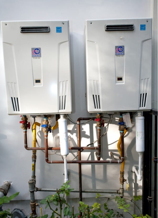 Fixing Home Appliances and Water Heater Maintenance. Double water heater outside the house